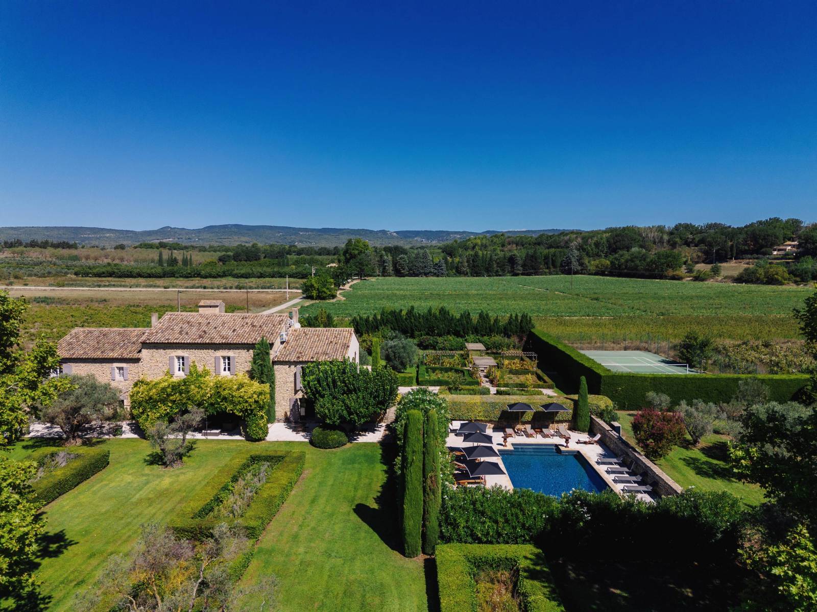 For rent at the foot of Gordes, stunning renovated Mas in a very peaceful setting with pool, summer kitchen and tennis court.