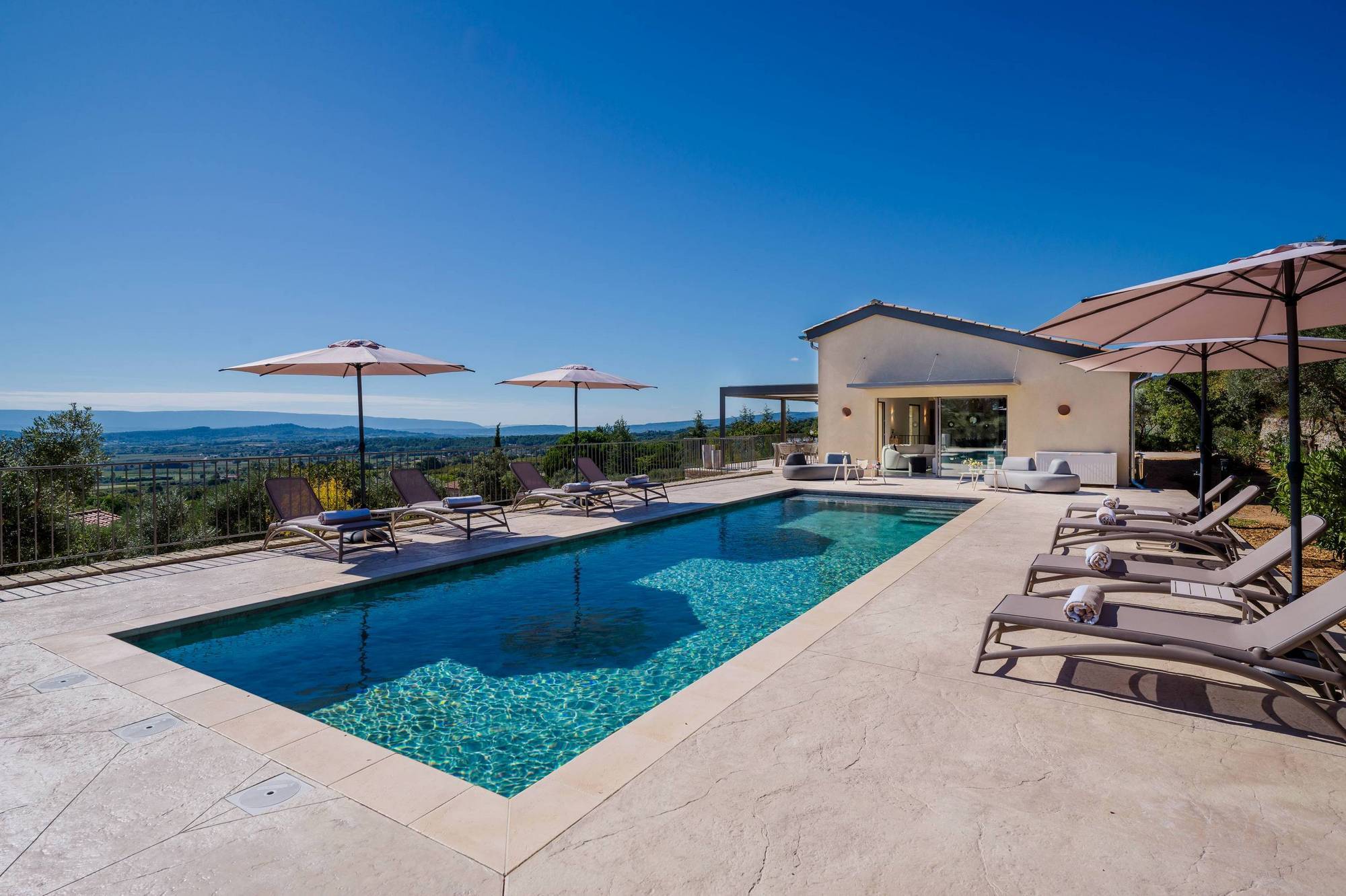 Spectacular contemporary stone villa with a pool, situated on a hilltop overlooking the valley, for sale near Saint-Saturnin-les-Apt.