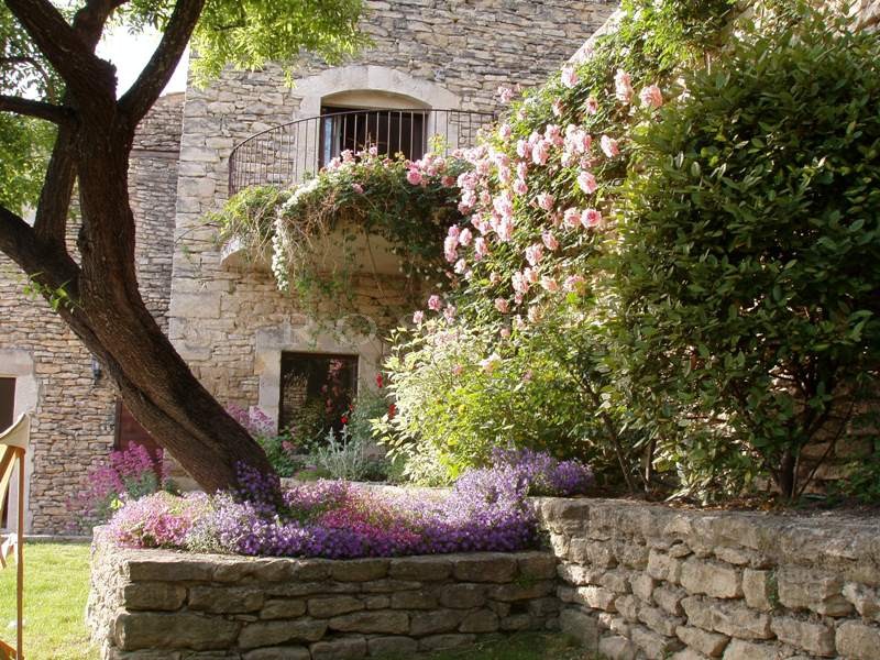 For sale in Luberon by Rosier, splendid stone house, in the medieval village of Gordes, ornated of hanging gardens and a swimming pool