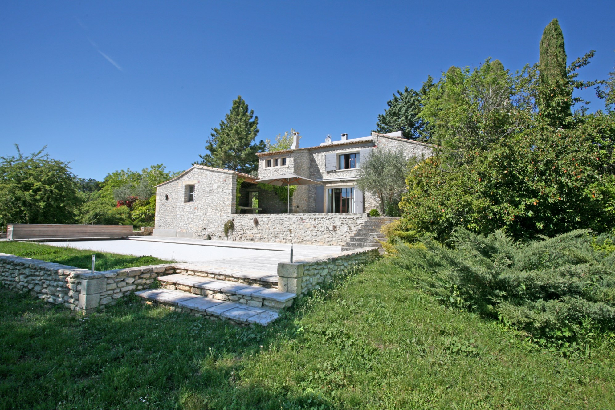 For sale in Luberon, near a superb hilltop village, elegant house with independent studio, park, views and swimming pool