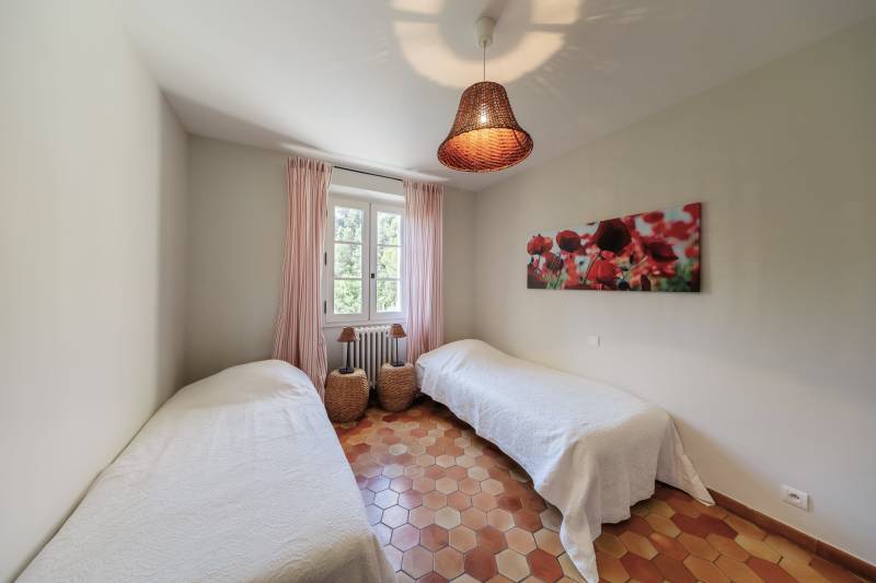 For rent in Gordes, stone Bastide in an elevated position with Luberon views, spacious grounds, and pool.