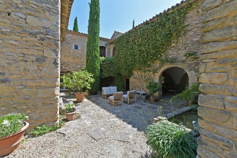 Authentic private stone hamlet with swimming pool and outbuildings set on 6 hectares of Provence in Gordes.
