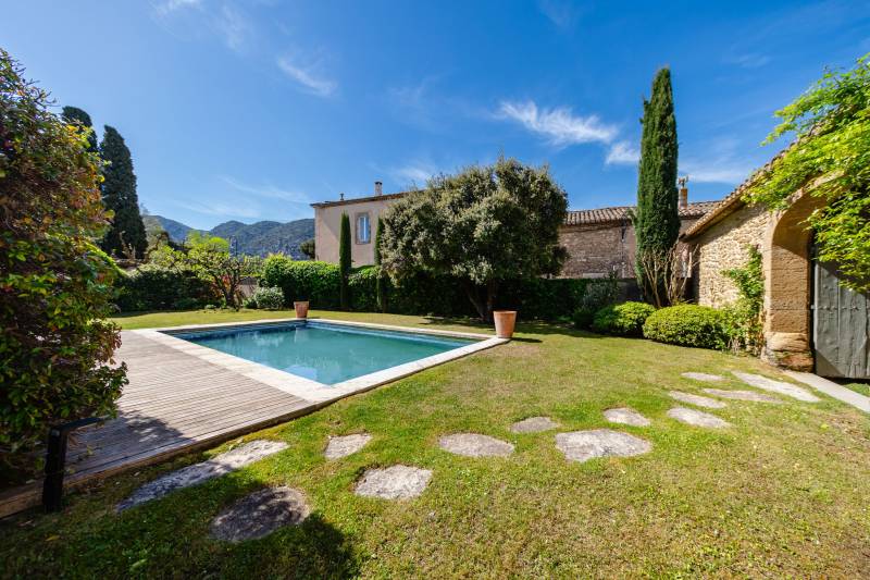 In the heart of the Luberon, elegant renovated estate, a true private hamlet comprising several buildings arranged around three courtyards and gardens, complete with a swimming pool.