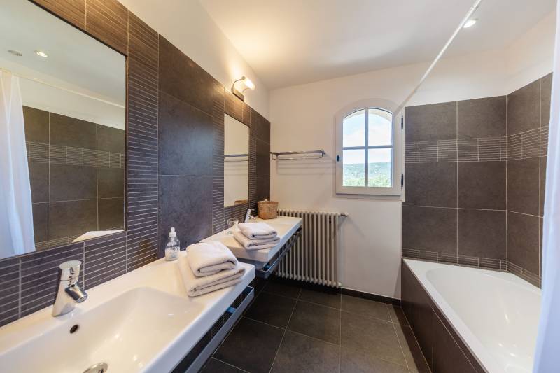 For rent in Gordes, stone Bastide in an elevated position with Luberon views, spacious grounds, and pool.