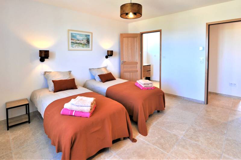 Contemporary stone villa within walking distance of Gordes, with heated pool, panoramic views and elegant outdoor living spaces.
