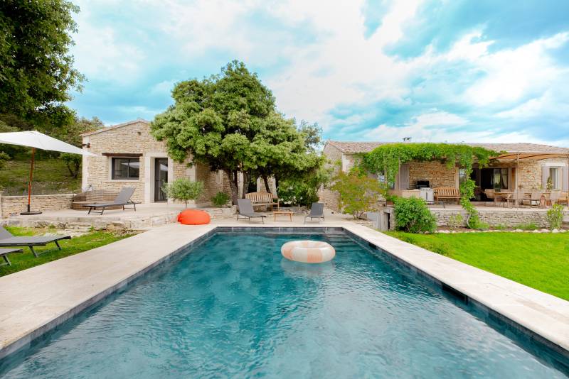 For sale in the hills above Gordes: an 8,500-square-meter property featuring two separate houses and a swimming pool.