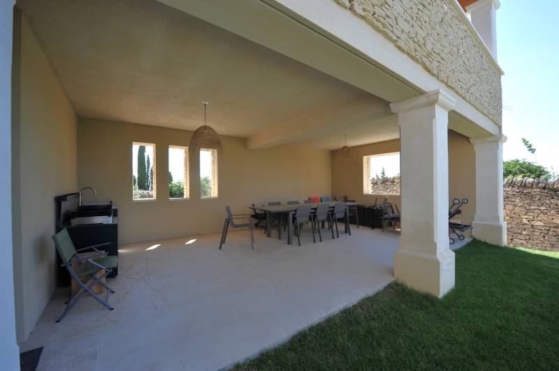 Contemporary stone villa within walking distance of Gordes, with heated pool, panoramic views and elegant outdoor living spaces.