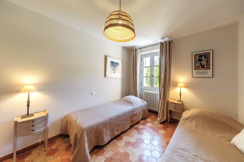 For rent in Gordes, stone Bastide in an elevated position with Luberon views, spacious grounds, and pool.