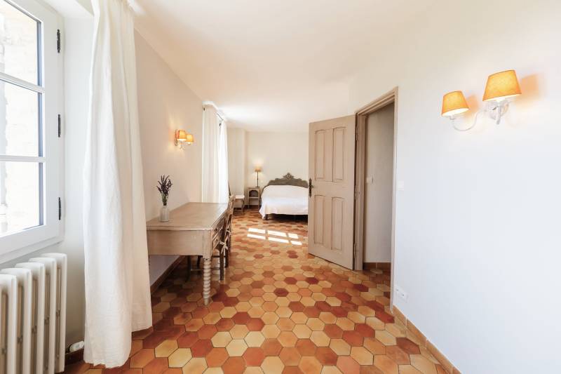 For rent in Gordes, stone Bastide in an elevated position with Luberon views, spacious grounds, and pool.