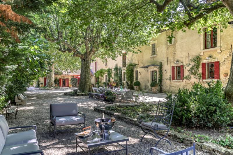 For rent near L’Isle-sur-la-Sorgue, beautifully renovated Mas with high-end amenities, 11 bedrooms, swimming pool and riverfront setting.