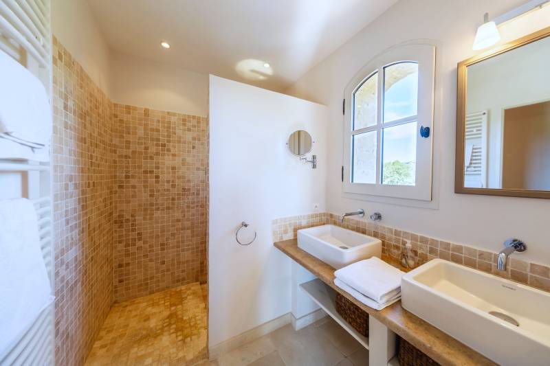 For rent in Gordes, stone Bastide in an elevated position with Luberon views, spacious grounds, and pool.