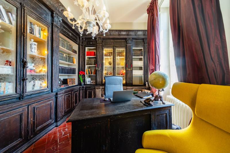 Study featuring custom bookshelves and sweeping terrace views