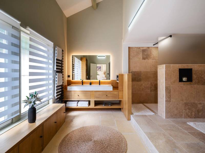 Contemporary Wellness Space: Modern shower room with double vanity and walk-in shower, blending modern comfort with old-world charm.