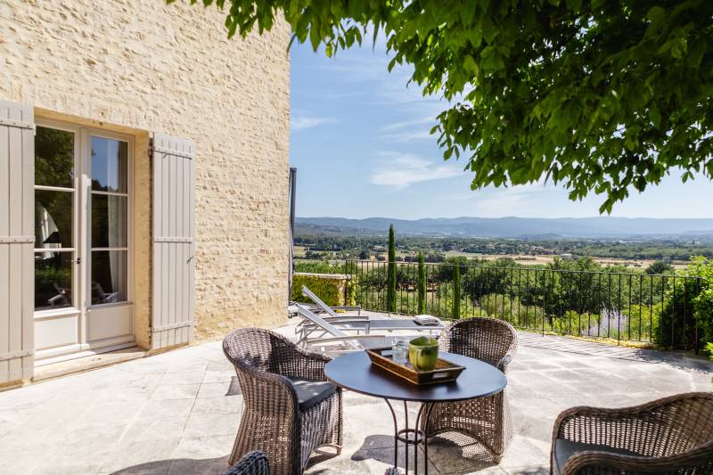 For rent in Gordes, stone Bastide in an elevated position with Luberon views, spacious grounds, and pool.