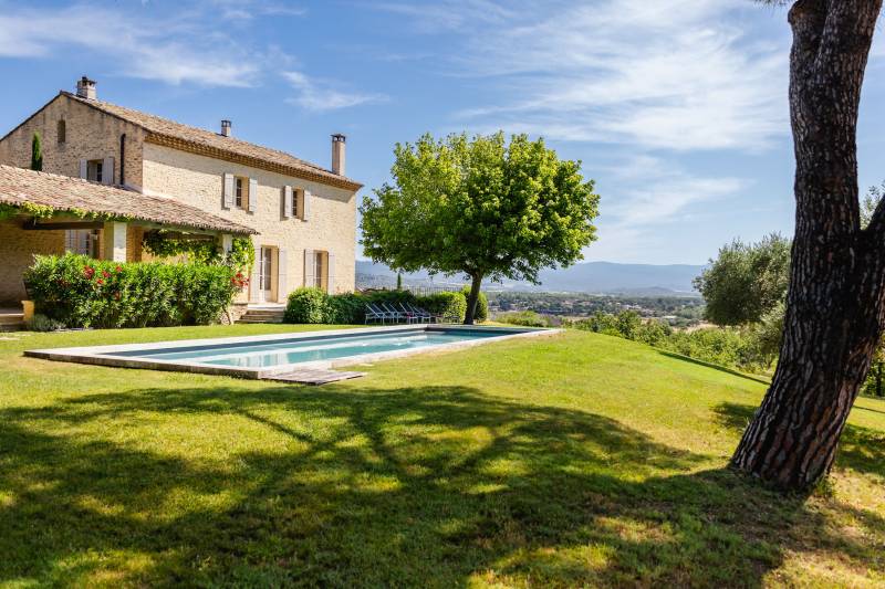 For rent in Gordes, stone Bastide in an elevated position with Luberon views, spacious grounds, and pool.