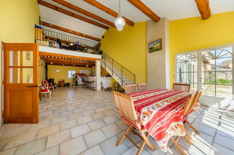 This historic 1850 farmhouse, located by the Canal de Provence, features 386 m² of living space across three levels, a converted barn, and a veranda. Surrounded by a lush garden and an infinity pool, it offers great potential for family living or guest ac