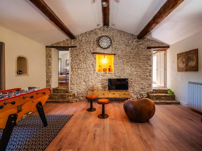 Family Leisure Space: Spacious hobby room under exposed rafters, showcasing the high-quality renovation of this 360 m² residence.