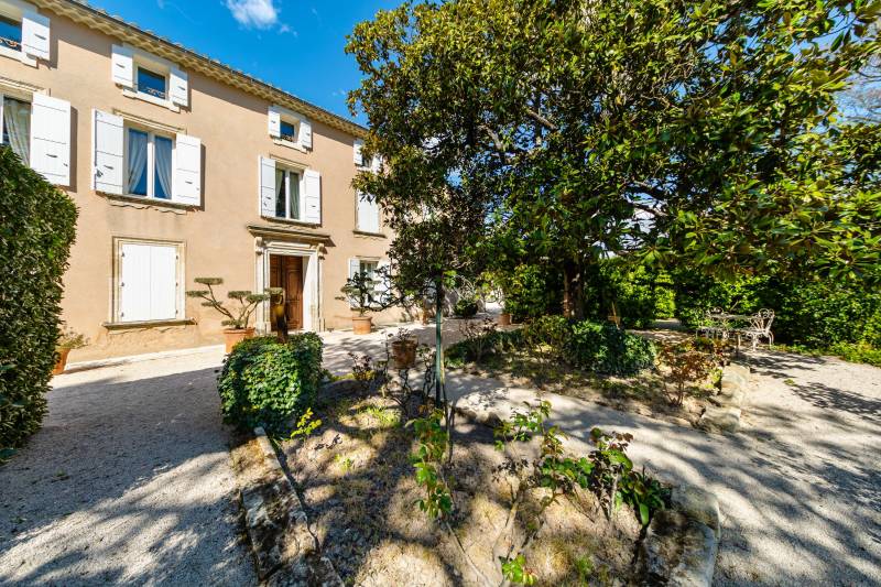 Charming 18th-century Provençal mas facade with traditional shutters and landscaped garden, Althen-des-Paluds.