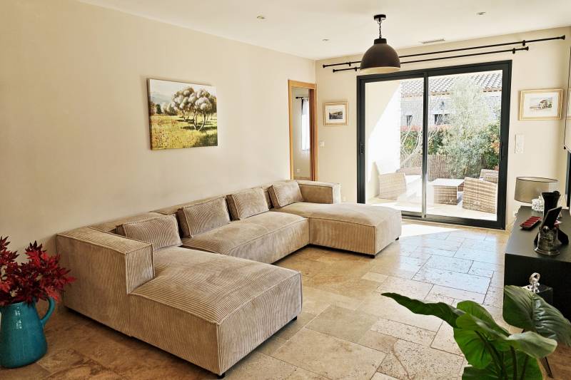 For sale in Gordes: a single-story stone house with a pool and garage in a quiet residential neighborhood.
