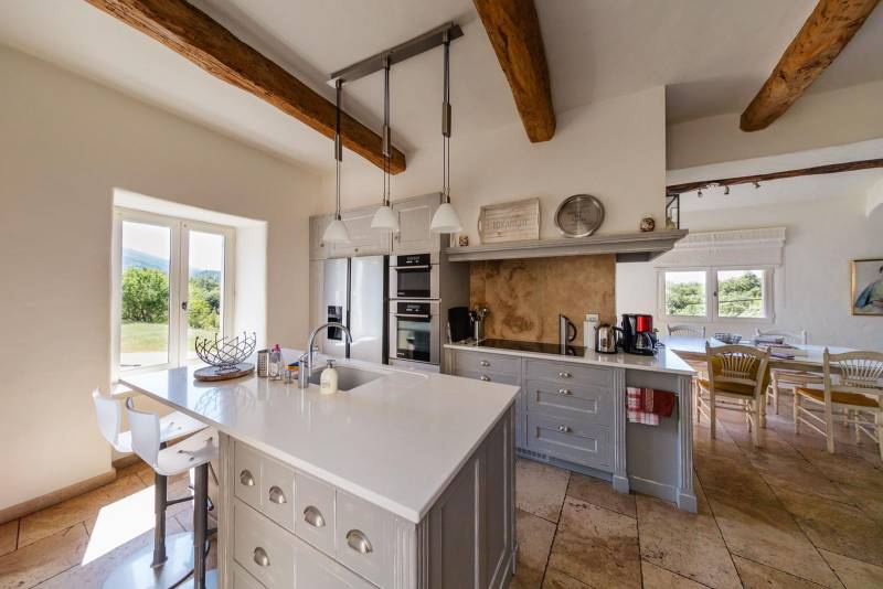 For sale, elegant stone house property with views of Bonnieux and Lacoste, recently restored with high-end amenities and separated annexes.