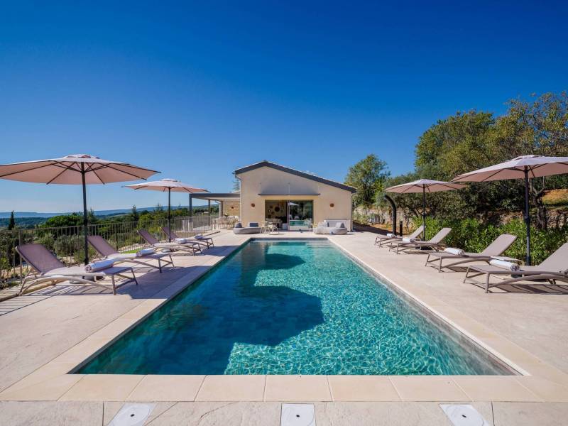 Spectacular contemporary stone villa with a pool, situated on a hilltop overlooking the valley, for sale near Saint-Saturnin-les-Apt.