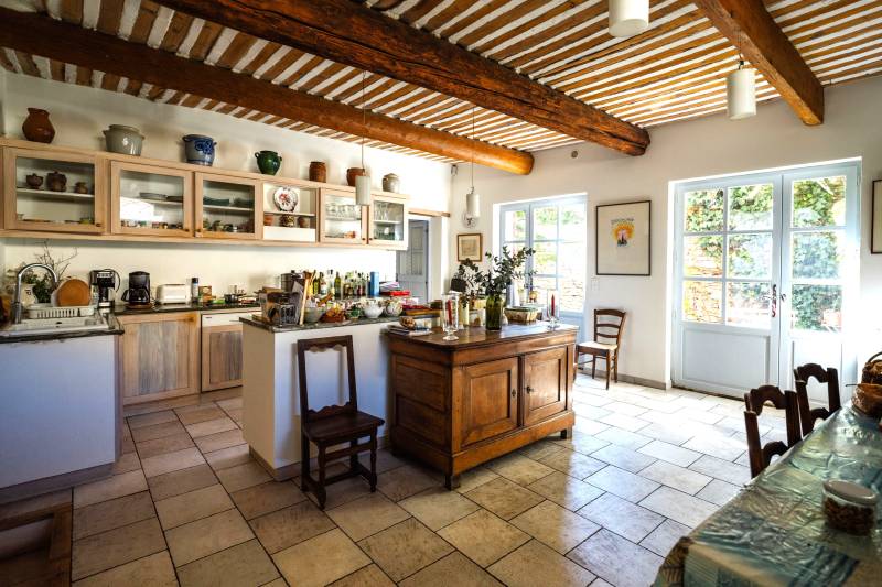 In the village of Cabrières-d'Avignon, a historic stone mansion with a swimming pool and garden near the castle.