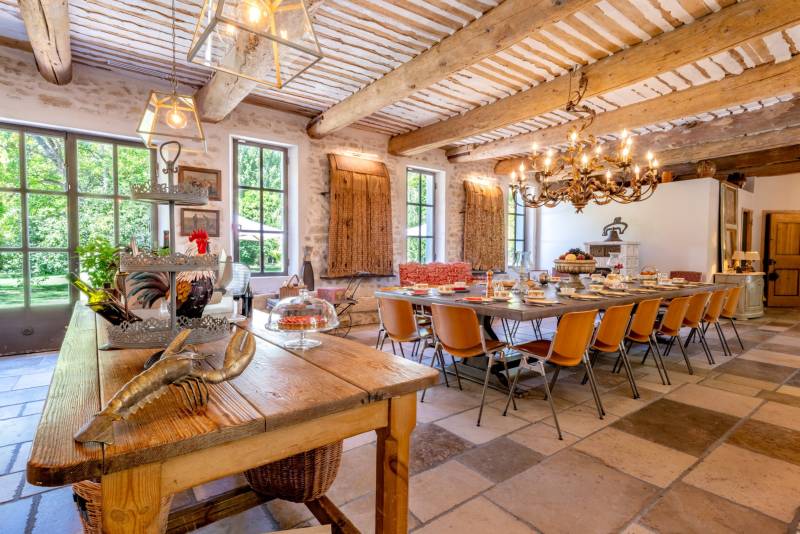 For rent near L’Isle-sur-la-Sorgue, beautifully renovated Mas with high-end amenities, 11 bedrooms, swimming pool and riverfront setting.
