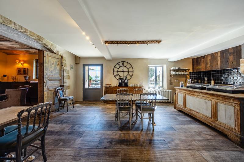 Elegant dining hall with historical character, bathed in natural light through large traditional windows.