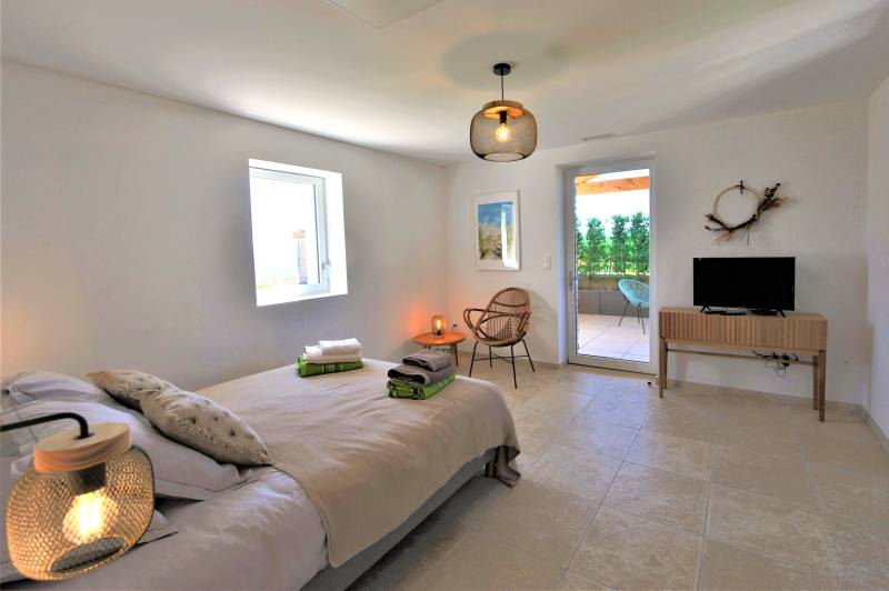 Contemporary stone villa within walking distance of Gordes, with heated pool, panoramic views and elegant outdoor living spaces.