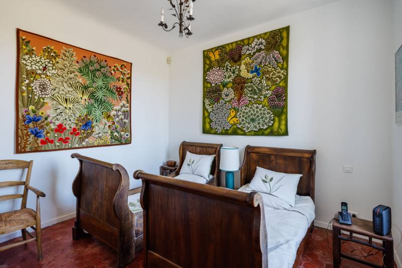 In the village of Cabrières-d'Avignon, a historic stone mansion with a swimming pool and garden near the castle.