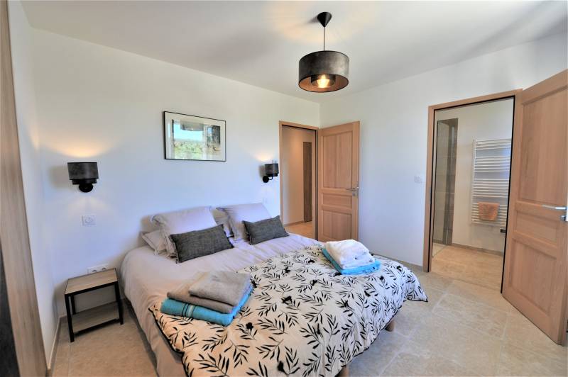 Contemporary stone villa within walking distance of Gordes, with heated pool, panoramic views and elegant outdoor living spaces.