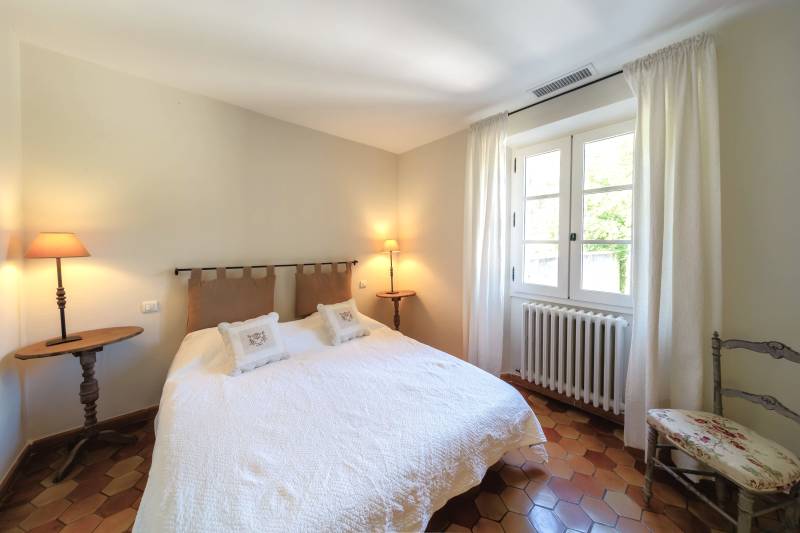 For rent in Gordes, stone Bastide in an elevated position with Luberon views, spacious grounds, and pool.