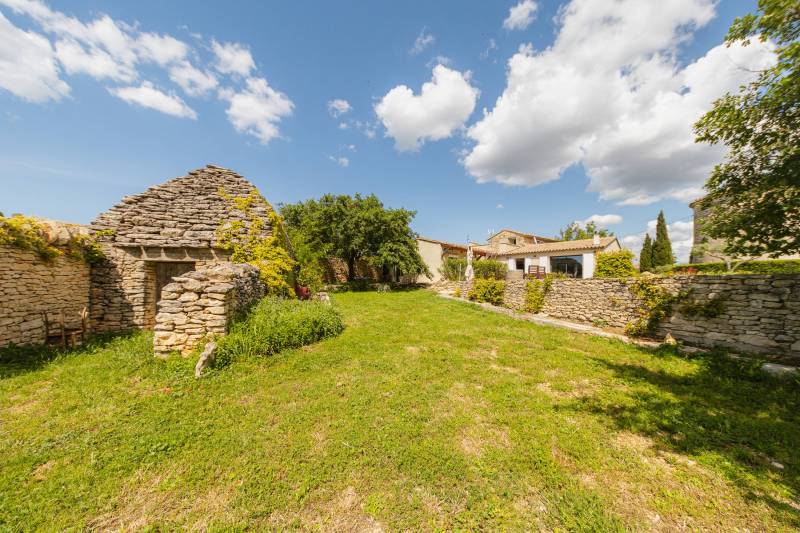 old farmhouse adjoining a more modern house, an authentic windmill, a swimming pool, a garden shed and a borie.