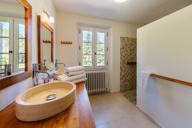 For rent in Gordes, stone Bastide in an elevated position with Luberon views, spacious grounds, and pool.