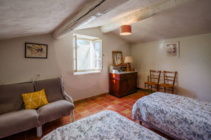 For sale in Cabrières-d’Avignon, stone house in a commanding position with landscaped grounds offering beautiful views of the Luberon.