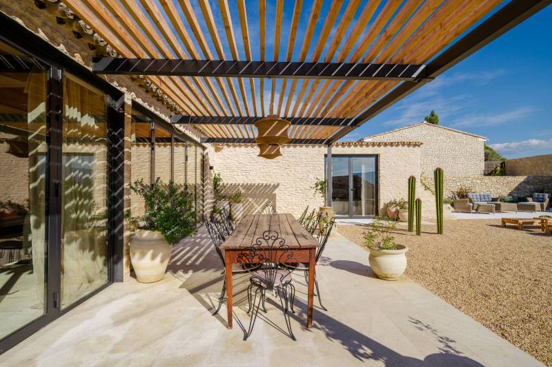 In a hamlet of Gordes, a renovated former sheepfold with a garden, swimming pool, and terrace offering views of the Luberon.