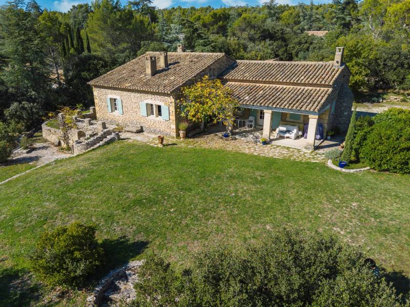 For sale in Cabrières-d’Avignon, stone house in a commanding position with landscaped grounds offering beautiful views of the Luberon.