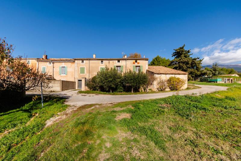 Character farmhouse divided into 4 rental units (from studios to 3-bedroom apartments), generating immediate monthly income.
