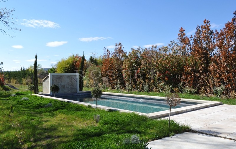 In the Luberon, a few minutes from Gordes and Roussillon, for sale, a contemporary stone house with a swimming pool and views of the Luberon