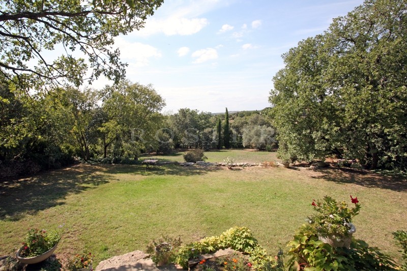 For sale, in a very sought after hamlet near Gordes in Provence, stone-clad house with outbuildings on 5,000 m² of landscaped grounds