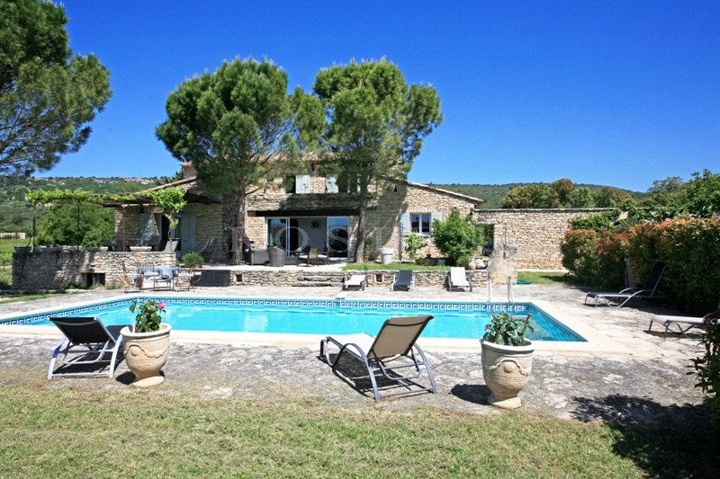For sale in Luberon, large stone house with guest houses in Luberon with swimming pool, views and terraces. 