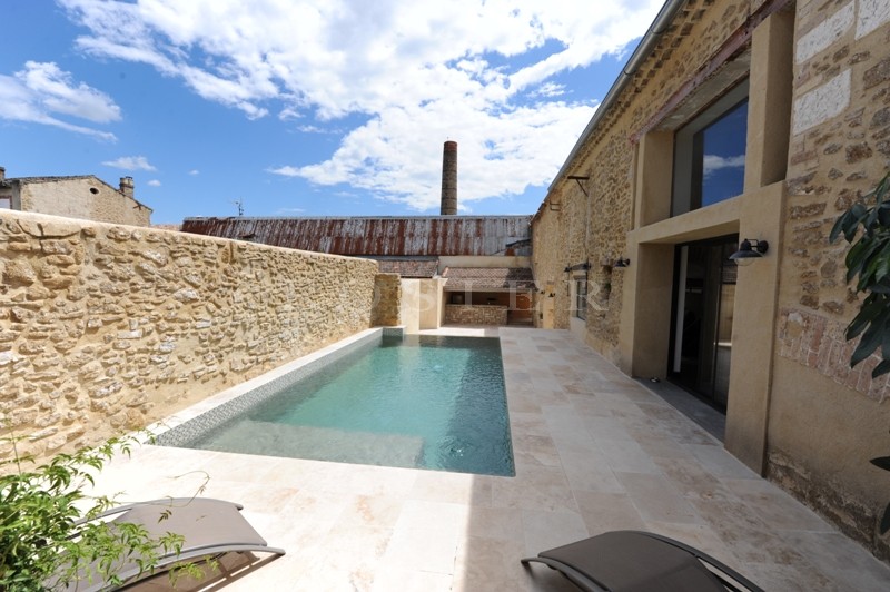 For sale, near Avignon, former factory entirely renovated, very contemporary with patio, fountain and swimming pool