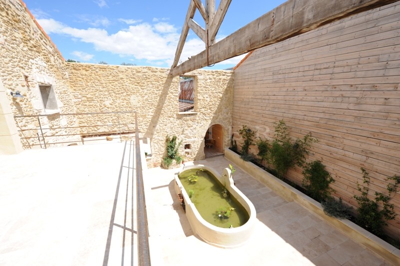 For sale, near Avignon, former factory entirely renovated, very contemporary with patio, fountain and swimming pool