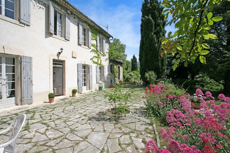For sale in Luberon, on theedge of superb hilltop village, old family mansion with garden