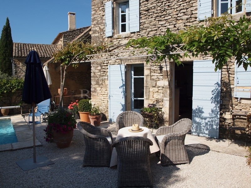 For sale, in Gordes, in a hamlet; beautiful old stone house, with terraces, garden and swimming pool