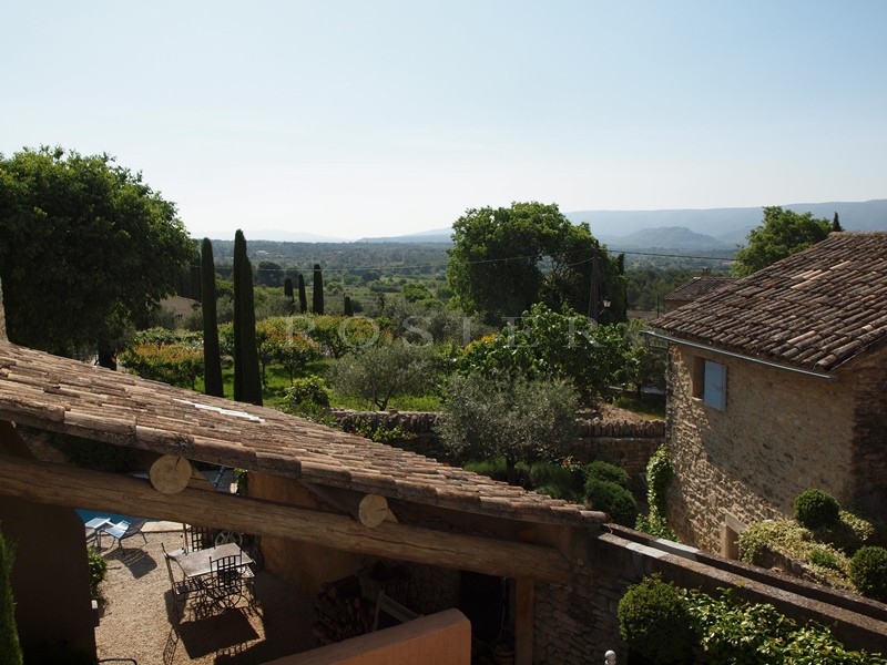 For sale, in Gordes, in a hamlet; beautiful old stone house, with terraces, garden and swimming pool