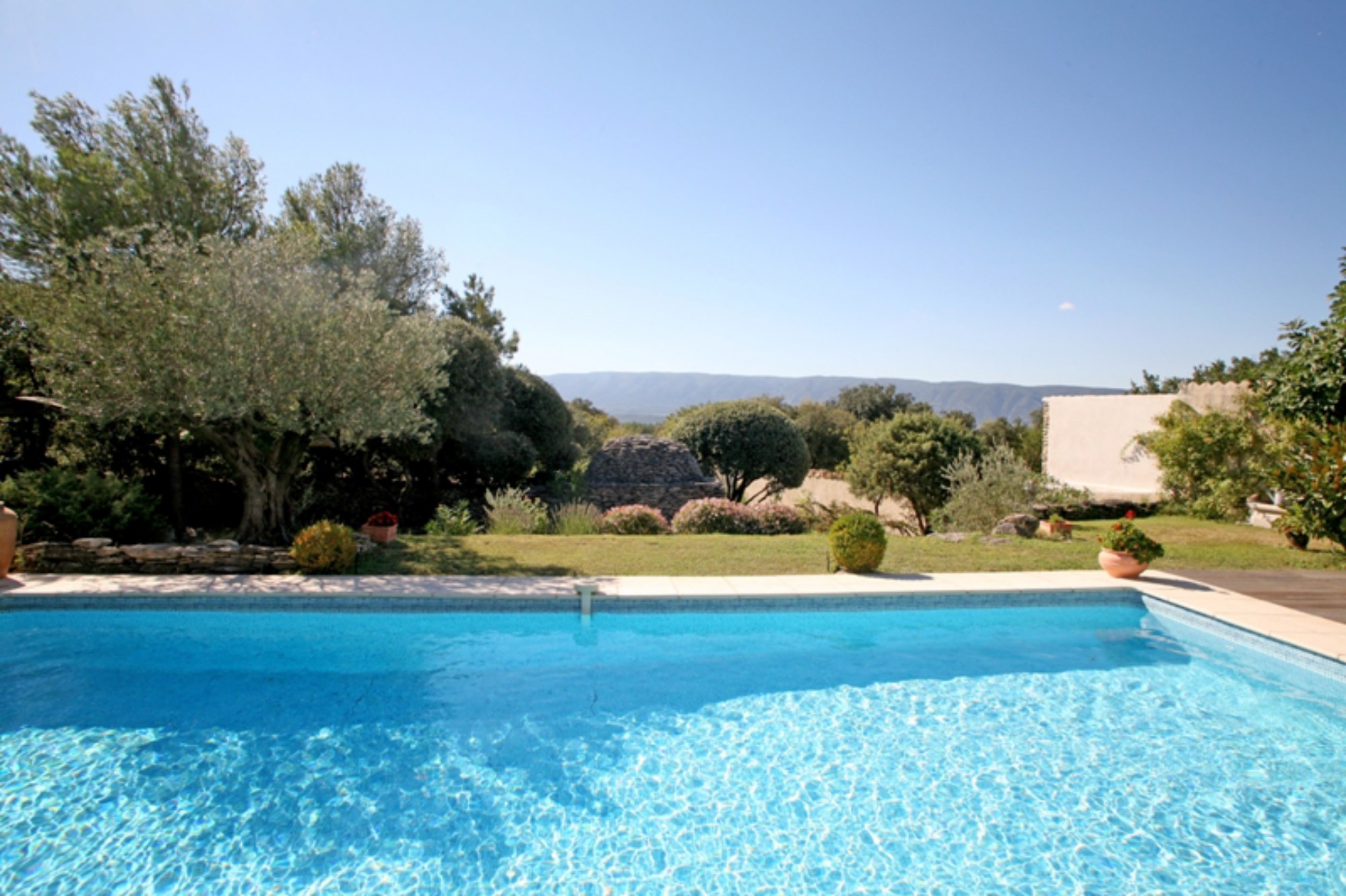 Near Gordes in Luberon, for sale, lovely house with terrace, garden, swimming pool, facing the Luberon offering stunning views